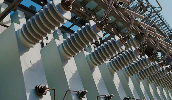 Close-up of high-voltage insulator stacks in a substation switchyard