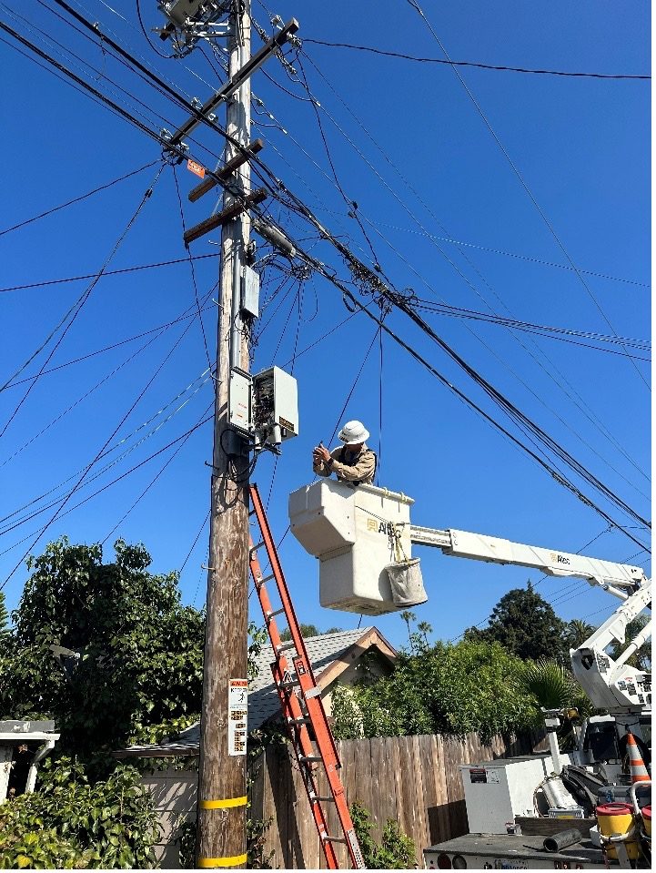 Bucket-truck work on a distribution pole