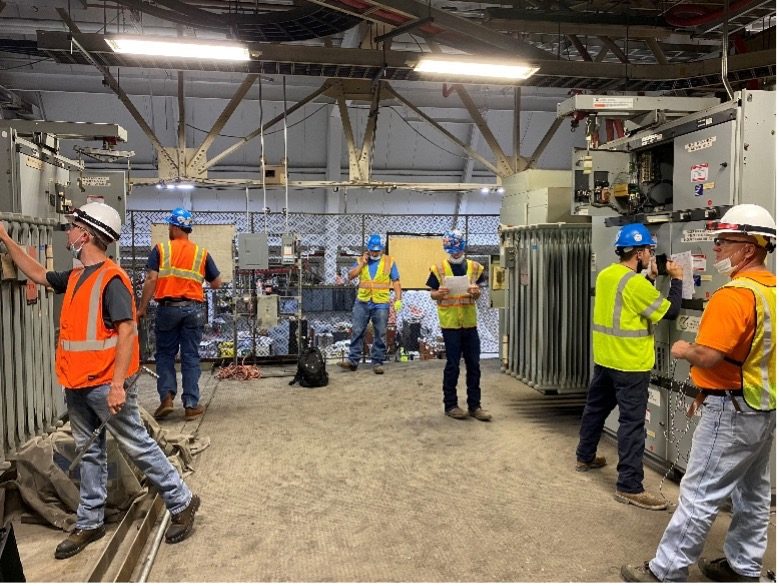 Crew working through switchgear procedures in the shop